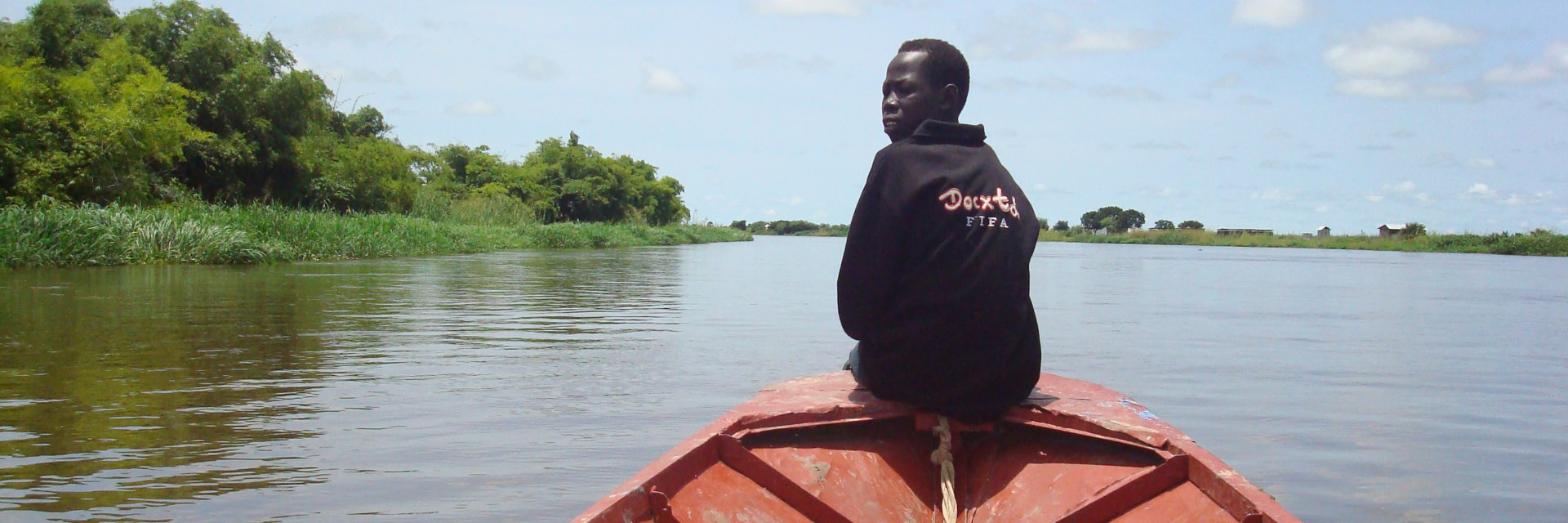 African Man on the edge of the boat